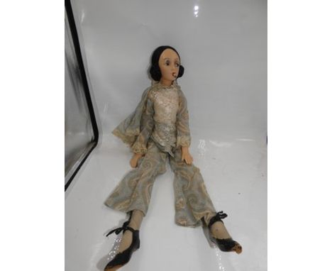 A vintage French smoking boudoir doll with brown eyes, painted black brows, red lips with cigarette, black hair in bunches, i