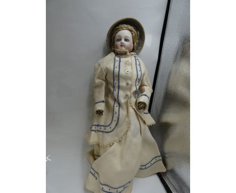 A pressed bisque 1870's fashion doll with swivel head, fixed blue eyes, brown feathered brows, closed mouth, pierced ears, bl