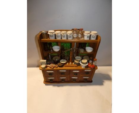 An old good quality wooden French shop display counter with two shelves to top, one top shelf and eight drawers to base and t