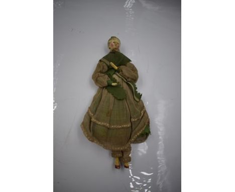 A 19th Century Grodnerthal Pedlar doll, painted wood with black painted hair with curls on the face, held by a yellow comb, f