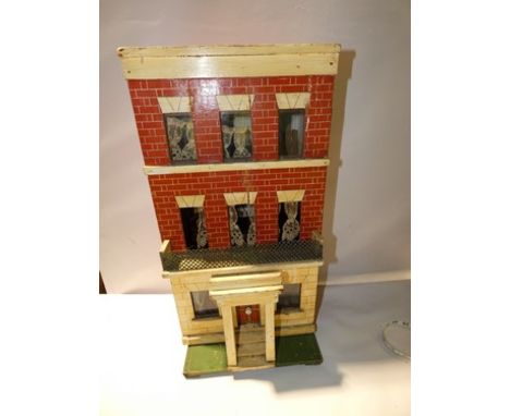 A German late 19th Century wooden Silber and Fleming box back dolls house, on a green painted base with red brick and sandsto