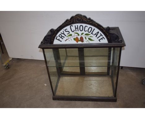 A Victorian Fry's Chocolate countertop display cabinet, the ebonised framed cabinet with enamelled Fry's Chocolate fan shaped