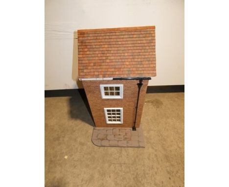 A 20th Century maisonette style dolls house with red brick facade and red tiled roof. The house opens at the front with 2 lev