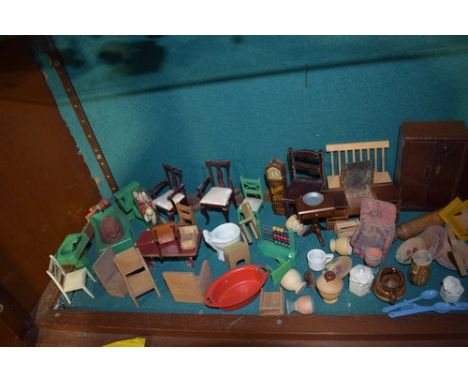 A shelf of assorted dolls house furniture including kitchen units, beds, chairs, baths, etc.