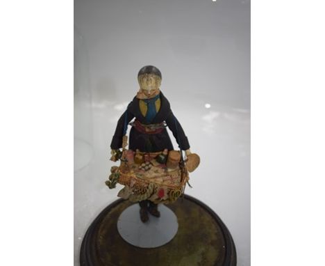 A 19th Century male Grodnerthal Pedlar doll, with painted black hair, painted eyes and lips, rosy cheeks, jointed body, dress