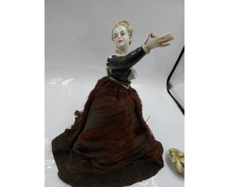 A rare German, possibly Dressel &amp; Kister, half doll with arms outstretched with a bowl of fruit, with head turned to the 