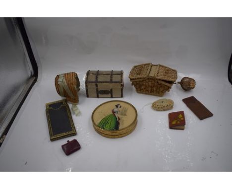 A collection of doll accessories including straw bonnet with light blue ribbon, a dolls trunk, a circular box depicting a lad