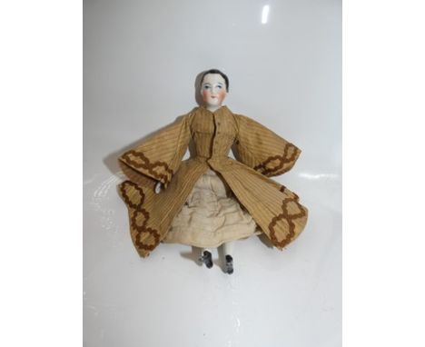 A good quality German China shoulder plate doll with blue painted eyes, painted brows and painted red closed mouth, black pai