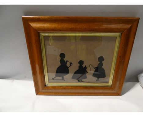 A Victorian silhouette depicting three children, one young girl riding a hobby horse, one young girl holding a doll, and one 