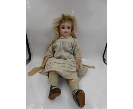 A J. Steiner bisque head bebe doll, with blue paperweight eyes, brown feathered brows, closed mouth, pierced eyes, blonde moh