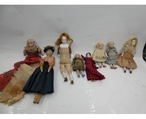 A collection of 7 assorted bisque, China and wooden dolls