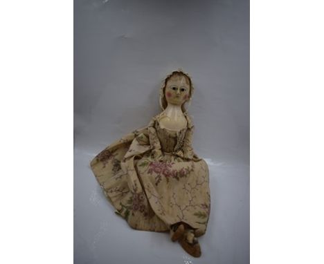 18th Century English wooden doll, inset dark enamel eyes, painted dotted eyelashes and eyebrows, painted mouth and rosy cheek