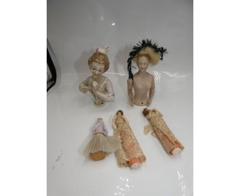 An interesting group of pin cushion and bottle stop half dolls comprising two bisque pin cushion dolls with blue painted eyes