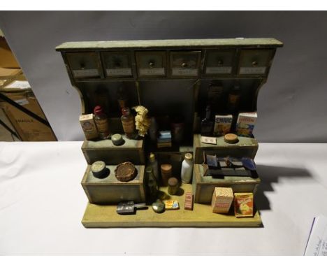 A 19th Century French wooden grocer's shop in green and yellow paint, with six drawers to top and graduated shelves and one d