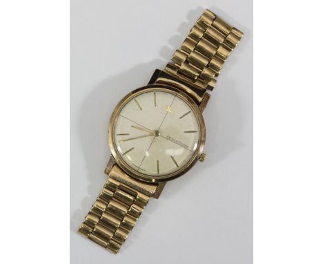 A gents 9ct gold Jaeger-LeCoultre wristwatch, the champagne crosshair dial with batons denoting hours, on later 9ct gold brac