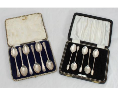 A cased set of six silver teaspoons with crossed hockey stick finials, Sheffield, 1933, maker's mark of Walker &amp; Hall, to