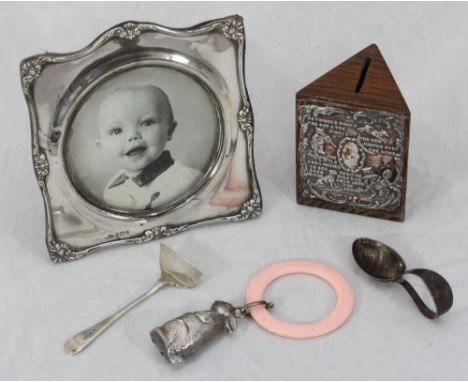 A silver photo frame with shaped border together with a silver-fronted money box embossed with Hey Diddle Diddle nursery rhym