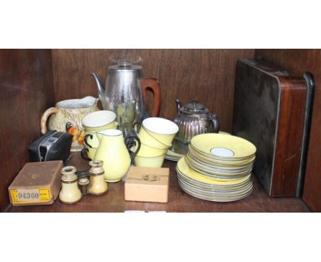 A small collection of yellow Crown Staffordshire pottery tea wares, two silver-plated teapots, a pair of opera glasses, and a