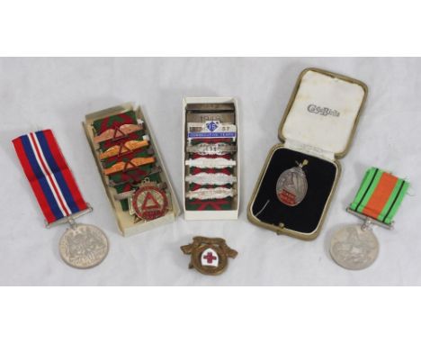 A WWII war medal and a Defence medal, together with a small collection of assorted safe driving medals and a boxed silver and