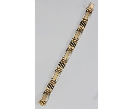 A 14ct gold and black enamel bracelet, of linked yellow and white gold bars inter spaced with solid panels with diagonal blac