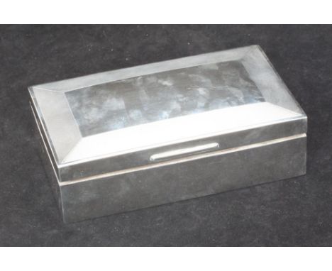 A silver rectangular wooden lined cigarette case, hinged cover with engine turned border, Birmingham, 1965, maker's initials 