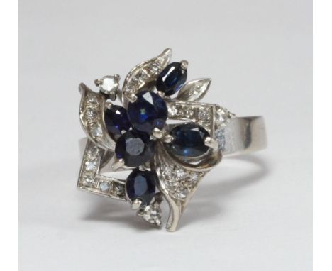 An 18ct white gold, diamond and sapphire ring modelled as a stylised leaf spray with six sapphires, ring size Q/R, gross weig