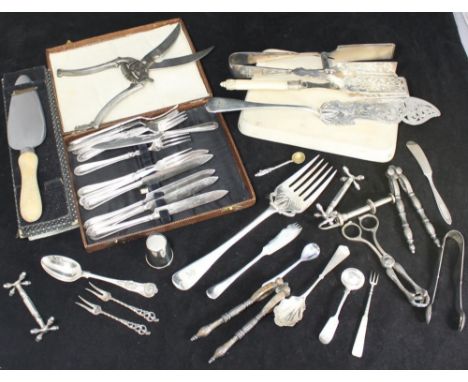 A quantity of silver-plated flatware including fish servers, knife rests, asparagus servers, secateurs marked DRGM, pickle pi