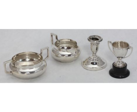 A silver 1920s sugar bowl and cream jug, London hallmarks, together with a silver squat candlestick and a small twin-handled 