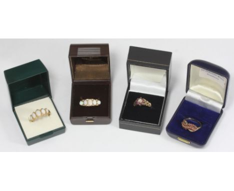 Two 9ct gold five-opal rings, a 9ct gold, ruby and diamond ring and a 9ct ruby ring, 12.6g (4) 