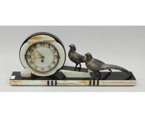 An Art Deco black slate and marble mantel clock modelled with two spelter figures of birds, 61cm long 