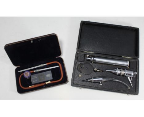 An audiologist's cased set together with a Carl Zeiss heat thermometers and a German Nursing School silver and enamel badge 