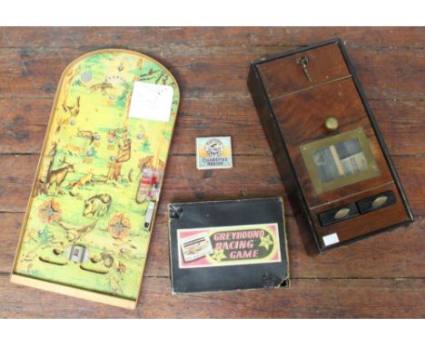 A wooden, coin operated cigarette dispensing machine, together with a boxed vintage Greyhound racing game and a bagatelle boa