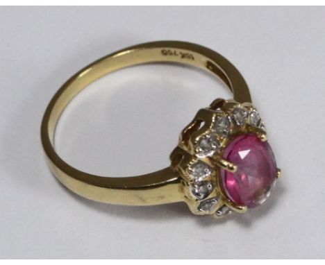 An 18ct gold ruby and diamond cluster ring, weighing 3.9 grams 
