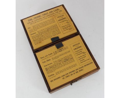 An early 20th century Boots the Chemist 'The Home First Aid Kit', comprising bandages and scissors etc. housed in wooden box 