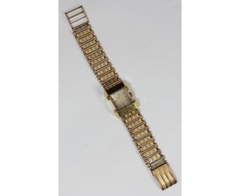 A ladies 1950s Omega wristwatch, with 9ct gold curved rectangular case, and engine-turned bracelet, 38.7 grams gross 