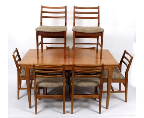 G Plan, an extending dining table, on tapering legs with eight ladder back chairs, 145cm long unextended