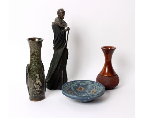 A circular ceramic bowl decorated with geometric patterns, 21cm diameter, two Australian carved vases and a resin figure of a