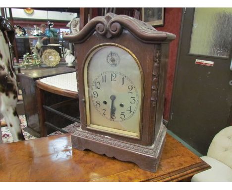 An early 20th century mahogany cased bracket clock with silvered face and Arabic dial, scrolled top