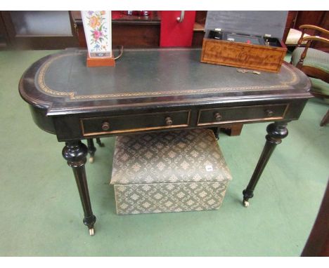 In the manner of ''Gillows'' a late Victorian ebonised with gilt relief writing table the tooled leather insert over two frie