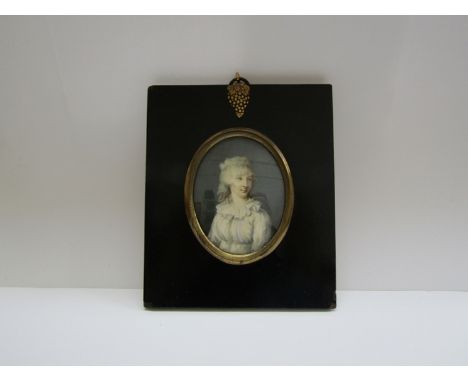 An early 19th Century miniature on ivory portrait of Anne Moffatt, oval setting in ebonised frame, label verso with details, 