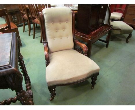 A mid Victorian walnut armchair the button back rest over scroll arms on turned supports and legs with ceramic castors 
