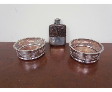 A pair of silverplate wine coasters and a hip flask 