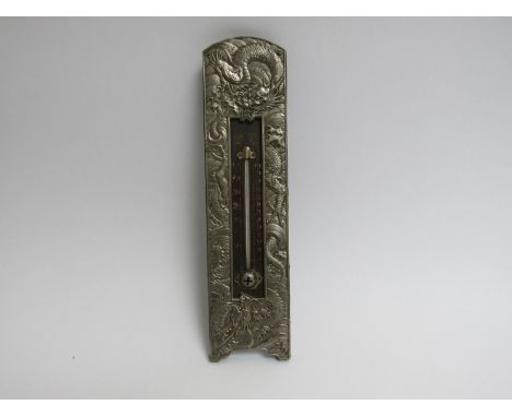 An embossed white metal wall hanging thermometer with dragon decoration, 23cm long