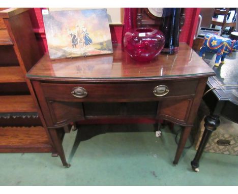 A George III style bow front side table the single frieze drawer over faux tambour front two sliding doors on square tapering