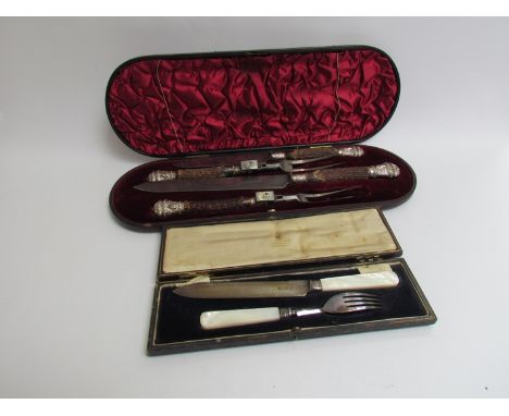 A cased Victorian carving set with embossed silver terminals with rams head detail, Sheffield 1888 and a silver and mother of