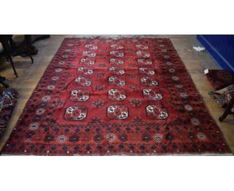 A Tekke Turkoman carpet, with central medallions on a red ground, within a multi border, 306 x 227 cm