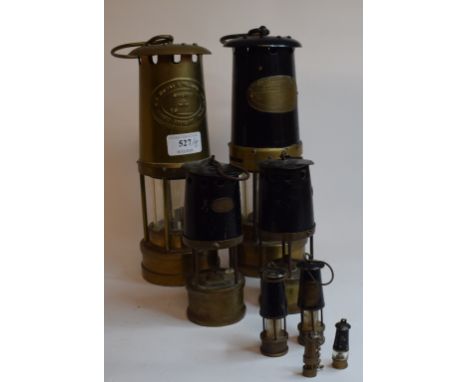 An E.Thomas & Williams of Aberdare miner's lamp, 27 cm high, another by the same, and three pairs of novelty miner's type lam