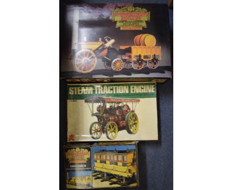 A Hornby 3 1/2 inch gauge real steam model train set, Stephenson's Rocket G100, a matching coach, G104, and a Bandai Garrett 