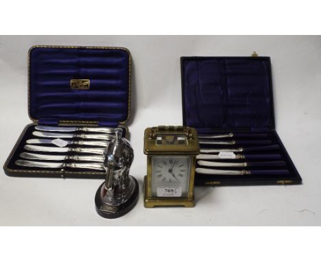 A Ronson elephant table striker, 22.5 cm high, a carriage timepiece, and two sets of tea knives, both cased (4) Condition rep