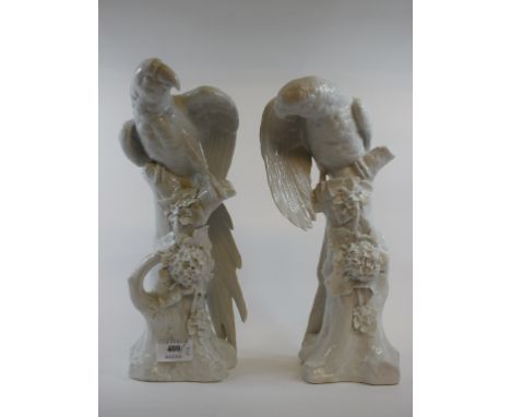 A pair of Sitzendorf porcelain parrots, on naturalistic bases, 32 cm high (2)